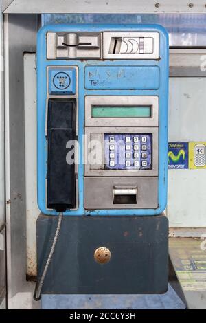 Huelva, Spain - August 16, 2020: Detail of Phone inside booth from Telefonica company in the town of Valverde del Camino. One of old and useless publi Stock Photo