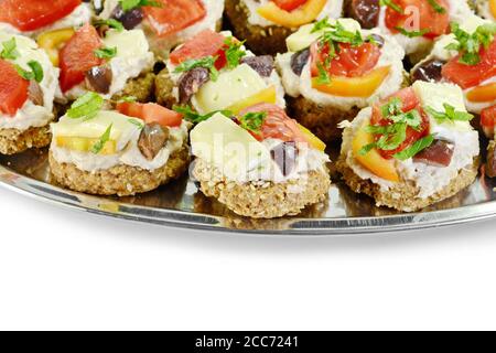 Delicious Appetizer Canapes with pheasant pate, cheese, paprika and tomatoes Isolated over White. Stock Photo