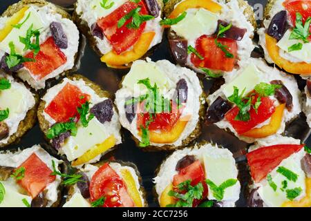 Delicious Appetizer Canapes with pheasant pate, cheese, paprika and tomatoes Isolated over White. Stock Photo