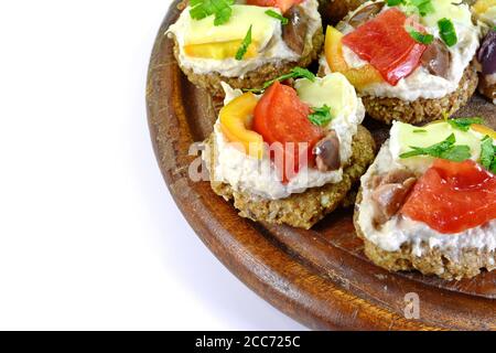 Delicious Appetizer Canapes with pheasant pate, cheese, paprika and tomatoes Isolated over White. Stock Photo