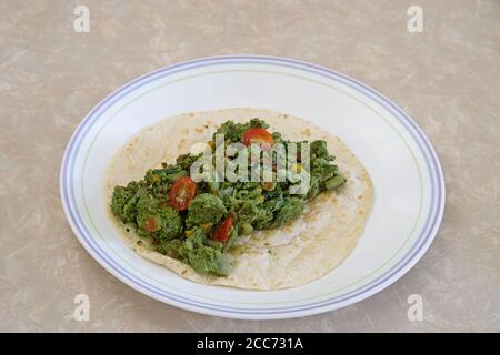 green eggs and vegetables on a flour tortilla Stock Photo