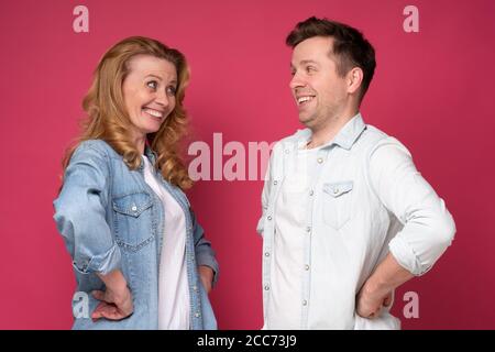 Mature sister and brother or friends looking at each other smiling. Stock Photo