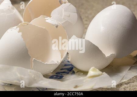 egg shells from baking eggs on empty butter wrapper Stock Photo
