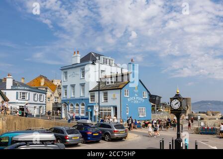 The Rock Point Inn and Town Clock on the seafront at Lyme Regis, a popular seaside town holiday resort on the Jurassic Coast in Dorset, SW England Stock Photo