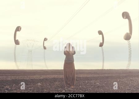 surreal moment of stressed woman who does not want to hear the giant phones that talk to her Stock Photo