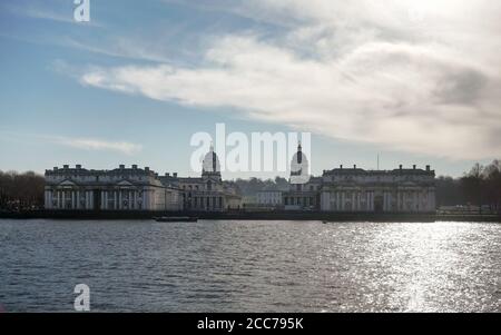 Royal Hospital School) over river Thames, on winter morning - strong sun backlight reflects in water. Stock Photo