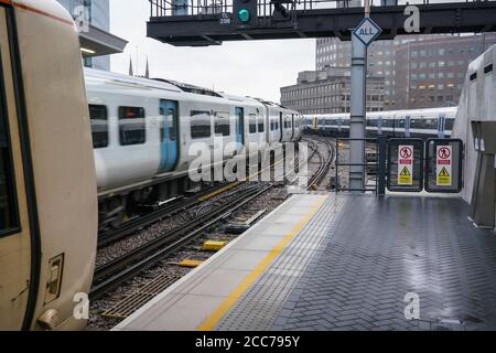 London, United Kingdom - February 01, 2019: Empty platform of London Bridge station on overcast day, Thameslink train arriving. Trains are used widely Stock Photo