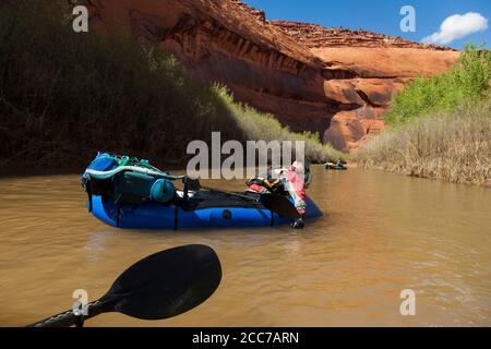 Mylène Jacquemart and Robert Hahn float lazily in their packrafts down the Escalante River near Scorpion Gulch, Utah. Stock Photo