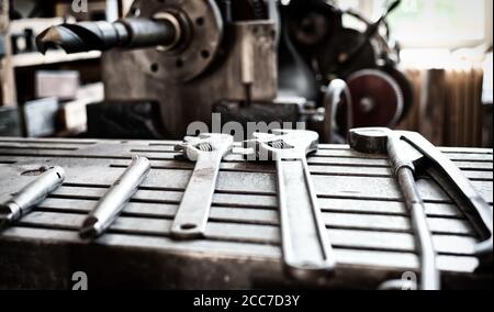 Vintage old metallic tools laying on a iron table surface Stock Photo