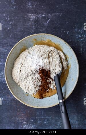 Tahini sugar mixture and flour, turkish coffee and baking soda in a ceramic bowl with a spatula. Stock Photo