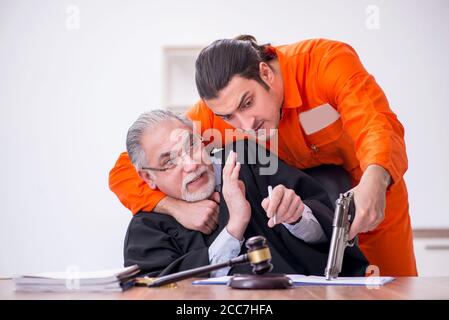 Old judge meeting with young captive in courthouse Stock Photo