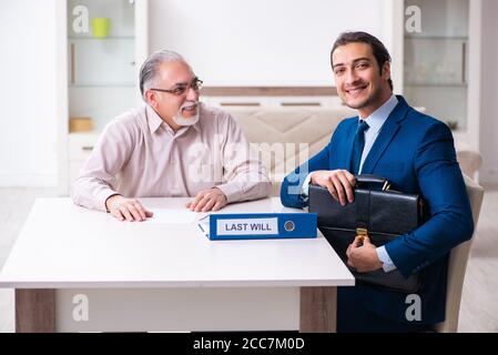 Young lawyer visiting old man in testament concept Stock Photo