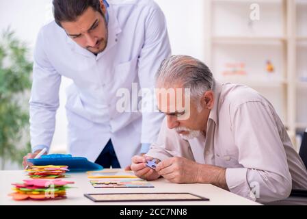 Doctor and patient suffering from the Alzheimer disease Stock Photo