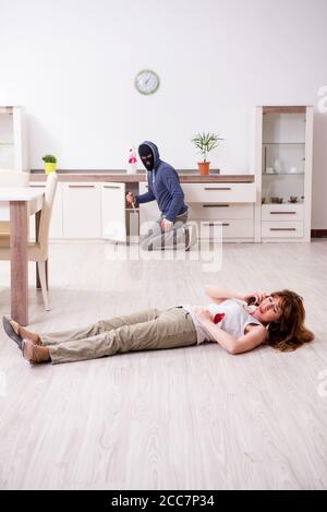 A knife in the blood, a smartphone and money dollars lie on the floor ...