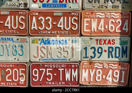 Carthage USA - September 7 2015; Editorial collection old vehicle number plates on wall recording old unique registration numbers. Stock Photo