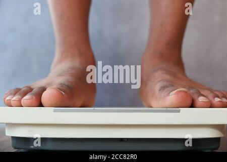 Obesity And Weightloss. Feet On Weight Scale. Pounds Stock Photo - Alamy