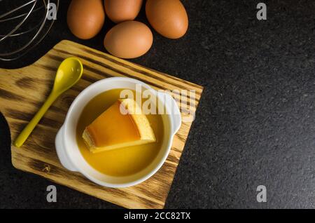 Traditional Brazilian dessert, milk pudding on dark background.