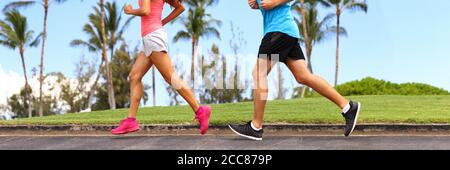 Runners legs sprinting outdoors banner- Sportive people racing running in park, closeup of running shoes. Healthy lifestyle and sport concept panorama Stock Photo