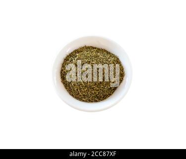 Dried Dill Powder in a White Bowl And White Background Stock Photo