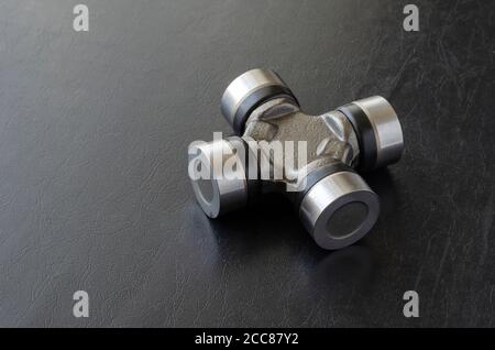 New cross joint for propeller shaft. Trade Auto parts, car service. Automotive industry. Selective focus. Stock Photo