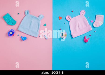 Funny baby's caps with ears over pink and blue background Stock Photo