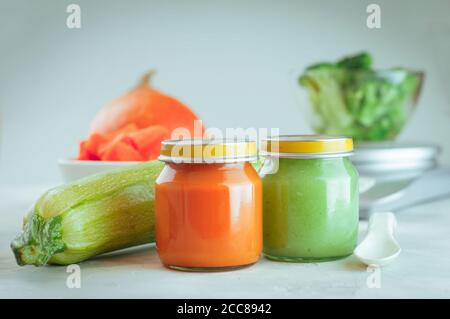 Glass jars with natural baby food on the table Stock Photo