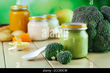 Jar with broccoli puree on the wooden background Stock Photo
