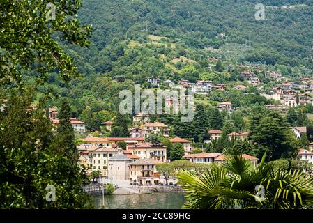Lenno Commune on Como Lake. Lombardy. Italy. Picturesque Italian Landscape with Old Town. Stunning Panorama with Mountains and Forest. Stock Photo