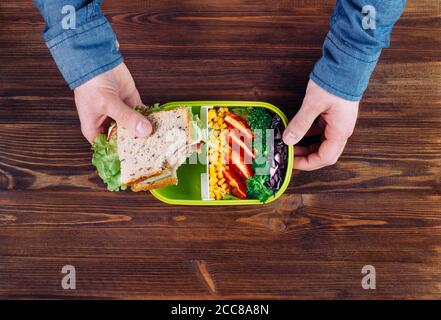 Males hands holding sandwich and thermos mug during eating his lunch Stock  Photo - Alamy