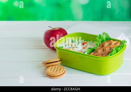 Open lunch box filled with rice and sandwich with copy space Stock Photo