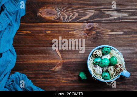 Painted quail eggs in a cup rustic wooden background Stock Photo