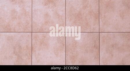 Floor tiles texture, abstract pattern of squares with pink ceramic tile. Marble wall background, wallpaper. Light brown wide panorama. Great bathroom Stock Photo