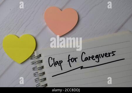 Clap For Caregivers write on a book isolated on office desk. Stock Photo