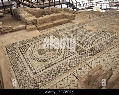 EPISKOPI, CYPRUS - 09/09/2018: Ancient mosaic at Kourion depicting Ktisis. Museum, exhibition. Stock Photo