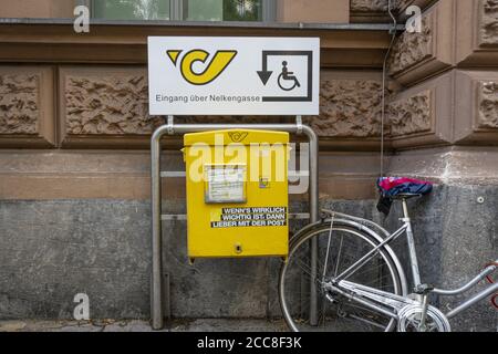 the yellow letterbox of the Austrian post office with a transparent ...