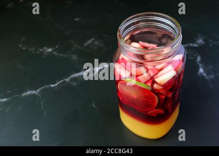 Vibrant Color of Homemade Red Wine Sangria before Mixing Isolated on Black Marble Table Stock Photo