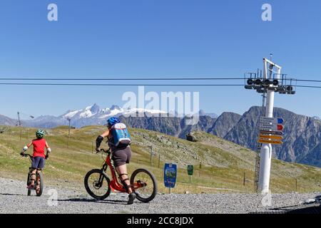 CHAMROUSSE, FRANCE, August 6, 2020 : Mountain bikers on top of the tracks. Well-known ski resort near Grenoble, Chamrousse is a summer destination as Stock Photo
