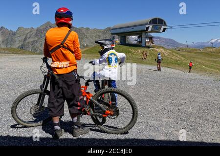 CHAMROUSSE, FRANCE, August 6, 2020 : Mountain bikers on top of the tracks. Well-known ski resort near Grenoble, Chamrousse is a summer destination. Stock Photo