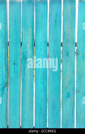 Old natural turquoise wooden fences boards as great background or texture. Vertical format. Close-up. Outdoors. Stock Photo