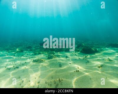 View of the seabed with sun rays reflected in the sand Stock Photo