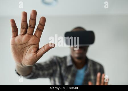 African man in glasses gesturing while playing in virtual reality game Stock Photo