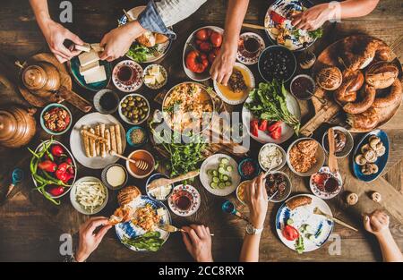 Traditional Turkish breakfast table and people taking various food Stock Photo