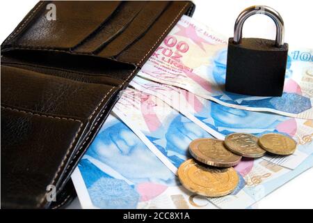 Black leather wallet, Turkish lira banknotes and coins and padlock on white background. Finance safety concept. Stock Photo