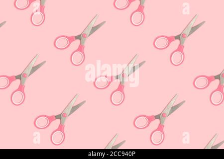 Scissors pattern on a pink pastel background. Monochrome composition. Stock Photo