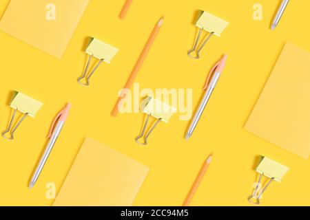 School supplies pattern on a yellow background. Monochrome creative layout. Stock Photo