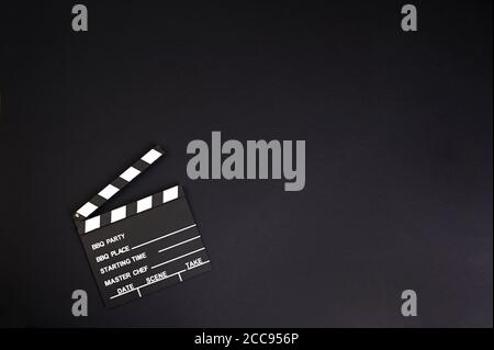 clapper board or movie slate.It is used in video production and film industry on black background. High quality photo. Copy space.  Stock Photo