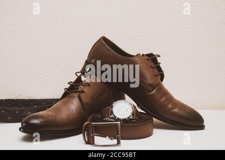 Brown wedding shoes for man with belt and watch Stock Photo