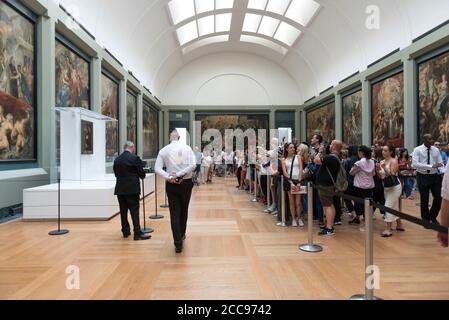 The Mona Lisa, by Leonardo da Vinci, at the Louvre Museum in Paris Tourists in front of the painting Stock Photo