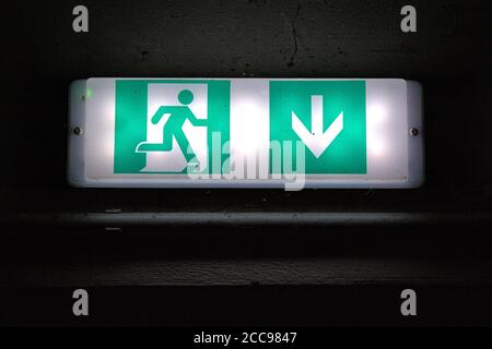 August 19, 2020, Schleswig, an illuminated sign with the pictogram and the note for an emergency exit in an underground car park in Schleswig above a door. | usage worldwide Stock Photo