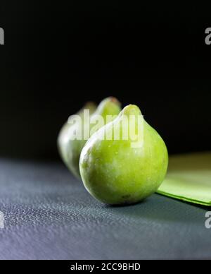 Close-up of fresh green Italian figs on dark background. Stock Photo